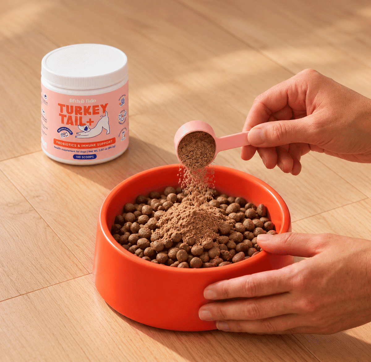 Scooping Turkey Tail+ powder onto kibble